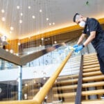 Hilton hotel being cleaned by man in mask