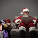 Santa responding to people on social media with his laptop