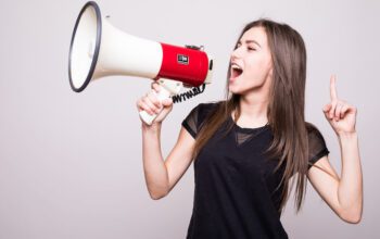 lady with brown hair shouting into megaphone, advocating for a brand