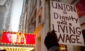 A protester holds up a sign at a demonstration outside McDonald's in Times Square in New York