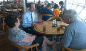 President and CEO, Adam Goldstein, (second from the left) meeting with guests onboard Grandeur of The Seas