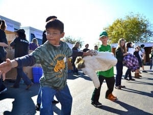 Students lend a helping hand at an event hosted by A Legacy of Giving. The program teaches children how to serve their communities and become more philanthropic.