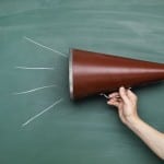 megaphone against a chalkboard