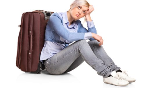 girl sitting by suitcase