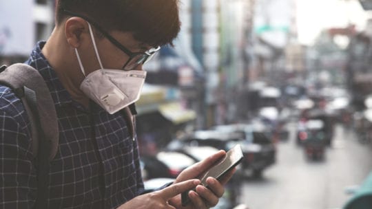 man on phone wearing facemask