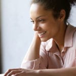 woman smiling working at computer