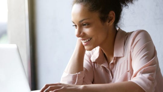 woman smiling working at computer