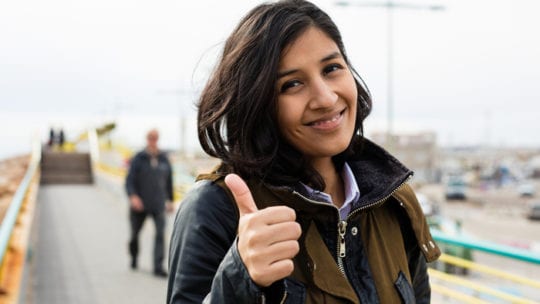 woman outside thumbs up