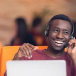 man on headset on latoptop