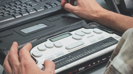 Typing on computer with Braille writer