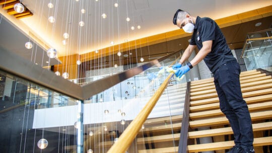 Hilton hotel being cleaned by man in mask