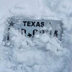 Texas license plate snowed over