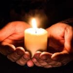 hands holding a candle