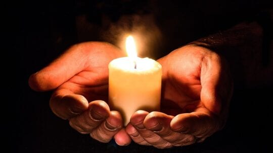 hands holding a candle