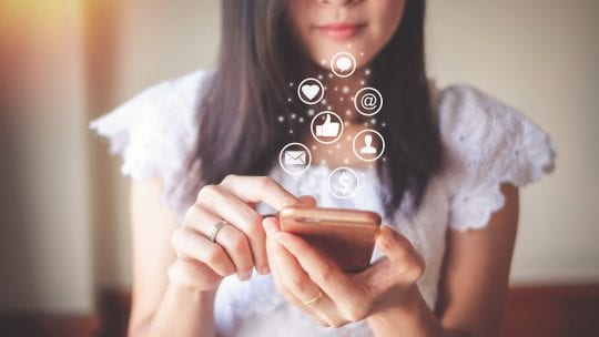 Woman using mobile phone for checking social media