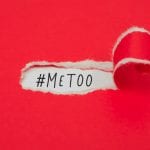 Red piece of paper peeling away to read "MeToo"