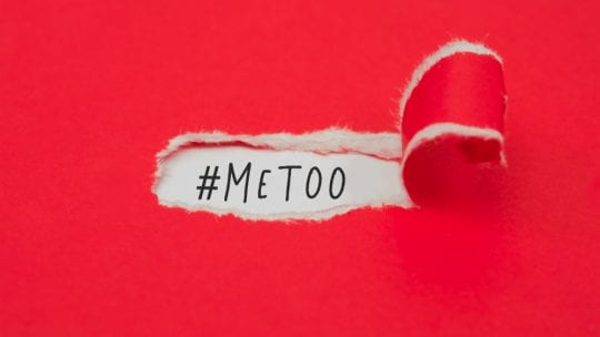 Red piece of paper peeling away to read "MeToo"