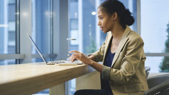 woman reading press releases on a computer