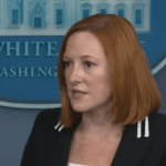 jen psaki in front of the White House logo at a press briefing