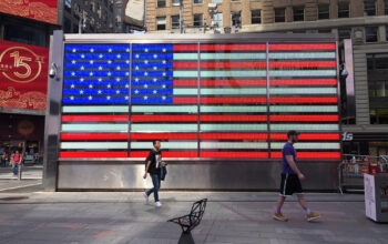 Patriotic American flag lighting in Times Square New York City