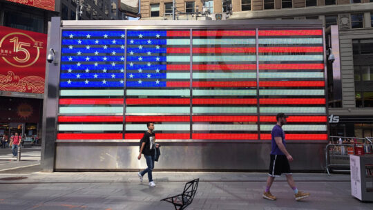 Patriotic American flag lighting in Times Square New York City