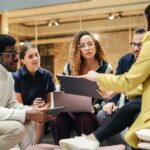 crisis team sits in a circle around a laptop