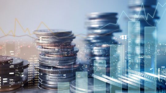 Double exposure of graph and rows of coins for finance and business concept