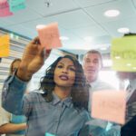 young woman discusses topics with company leadership