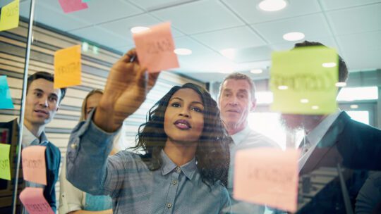 young woman discusses topics with company leadership