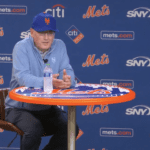 Mets' owner Steve Cohen sits down at a Mets round pub table for a press conference on June 28