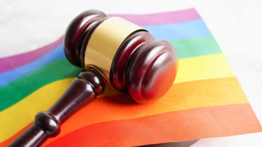 Gavel for judge lawyer on rainbow flag, symbol of LGBT pride month celebrate annual in June social of gay, lesbian, bisexual, transgender, human rights.