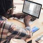 man on a laptop logging into linkedin, where he may post something on thought leadership in his industry.