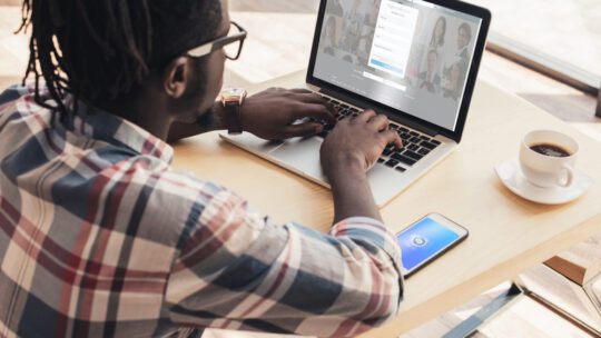 man on a laptop logging into linkedin, where he may post something on thought leadership in his industry.