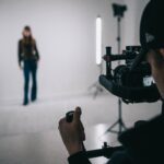 A male photographer taking a photo of the blurred silhouette of a model.