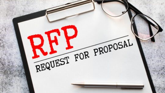 RFP- Request For Proposal written in notebook.