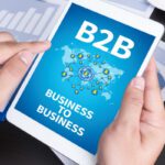 B2B BUSINESS TO BUSINESS Modern people doing business, graphs and charts being demonstrated on the screen of a touch-pad,blank screen copy space