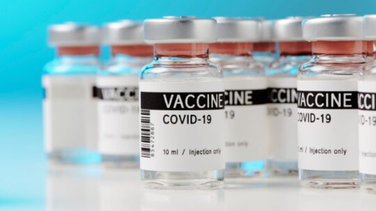 ampoules with Covid-19 vaccine on a laboratory bench. to fight the coronavirus / sars-cov-2 pandemic.