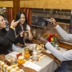 King”s Hawaiian helps Northeast travelers “Roll Home in Style” with a one-of-a-kind Thanksgiving meal served in custom dining cars in Philadelphia Friday, Nov. 18, 2022. (Mark Stehle/AP Images for King's Hawaiian)