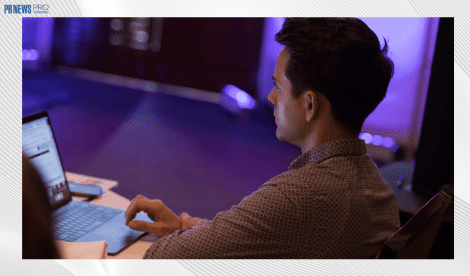 man looking at laptop at conference