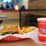 Wendy's burger set and drink on table. Wendy's is the world's third largest hamburger fast food chain with approximately 6,650 locations.