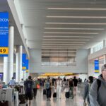 screens down in an airport show how the crowdstrike outage affected other businesses, causing tertiary crises.