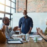 man makes career change to public relations, receives applause at meeting