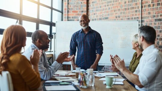 man makes career change to public relations, receives applause at meeting