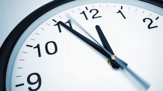 5 min before 12 o`clock on a wall clock