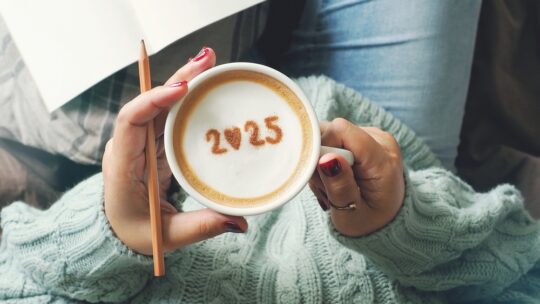 New year 2025 celebrated coffee cup with number 2025 on frothy surface of cappuccino in coffee cup