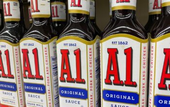 Grocery store shelf with A.1. steak sauce bottles, side view
