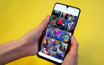Woman surfing on TikTok showing most popular TikTok videos in a grid on the app on her phone.