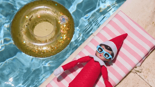 Elf on the Shelf lies by the pool at a Beaches resort