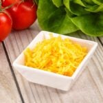 Shredded yellow cheese in the bowl