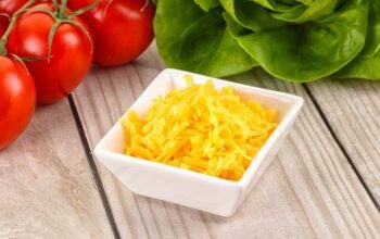 Shredded yellow cheese in the bowl